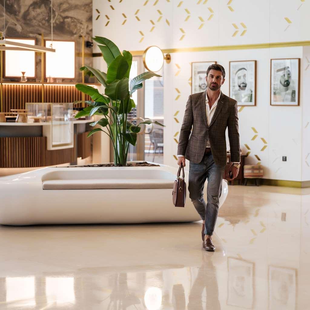 The First Collection Dubai Business Bay Hotell Interiør bilde A man walking through a lobby